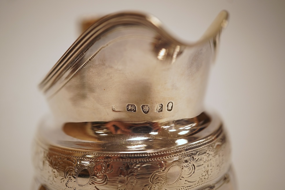 A George III engraved silver helmet shaped cream jug, with fluted body, Soloman Hougham?, London, 1800, height 97mm, 4.5oz (repair).